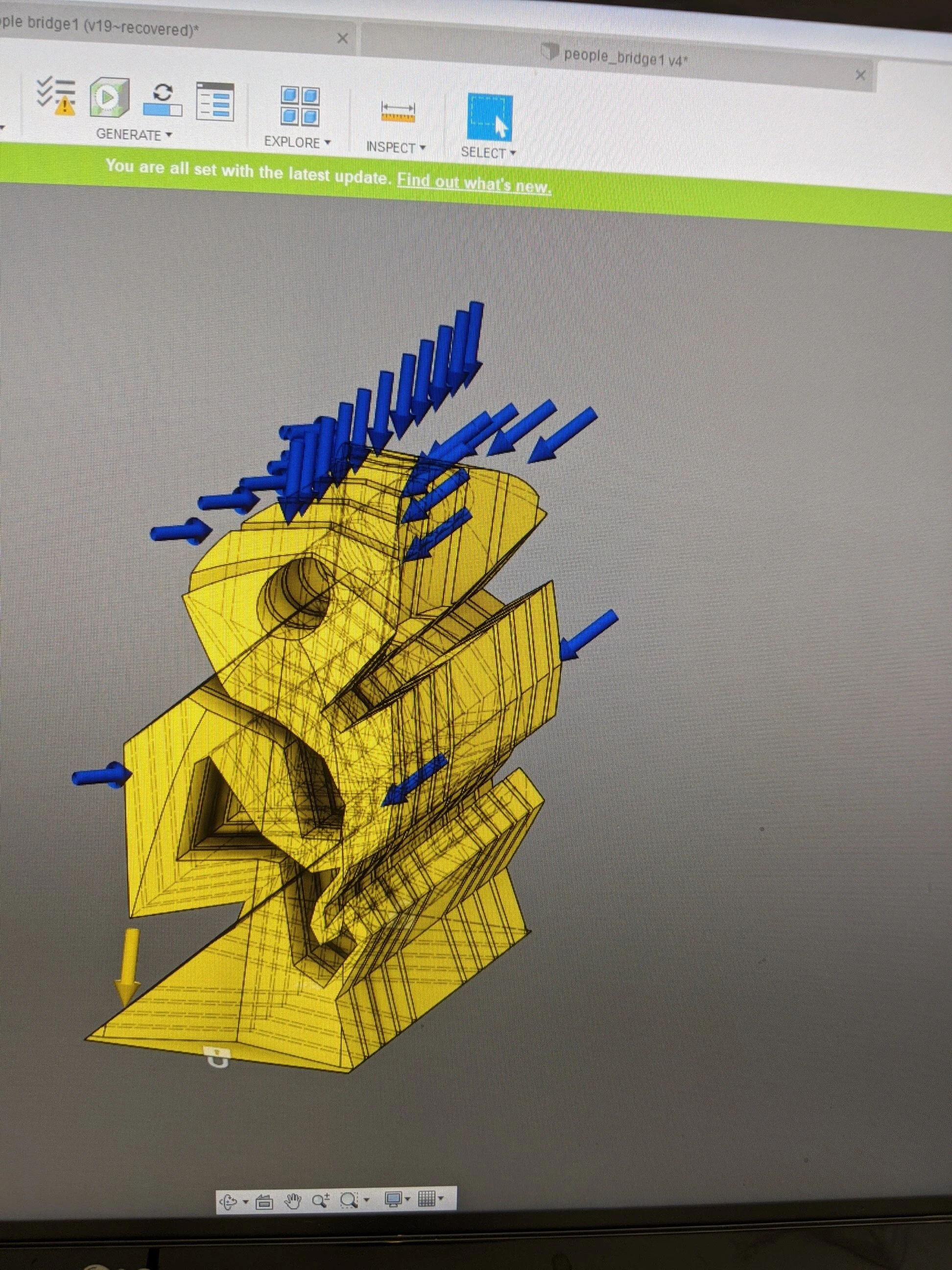 the section that was acted upon by the topology optimization algorithm. blue indicates the forces acting on the starting shape.